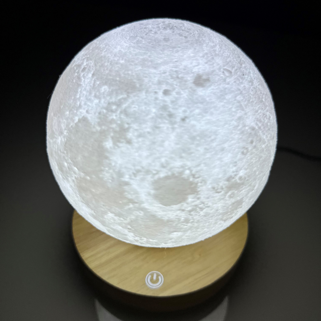 Levitating Moon Lamp glowing above a wooden base with touch control. A 3D floating moon light perfect for home decor or a unique gift.