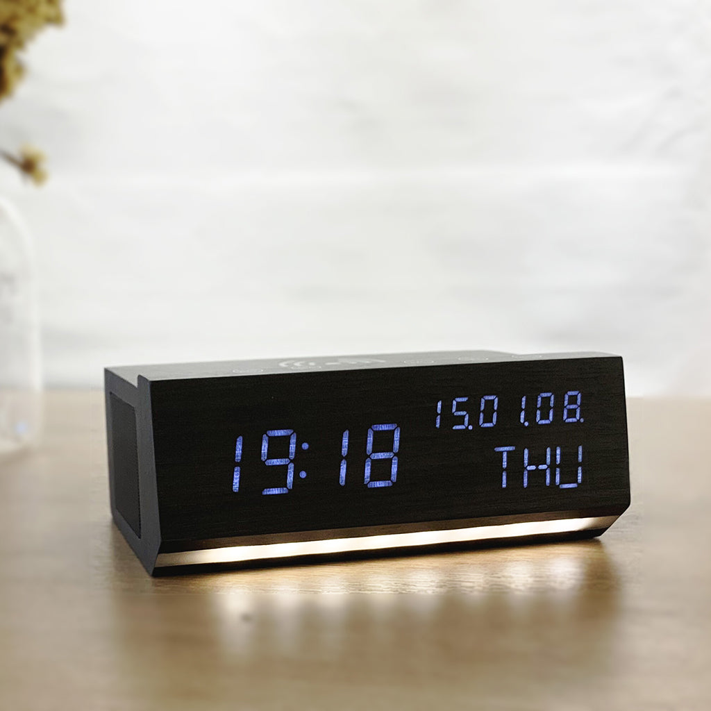 Shop Wireless Charging Wood Alarm Clock with LED display, Bluetooth speaker, and FM radio. Sleek black wood design perfect for bedside or desk use.