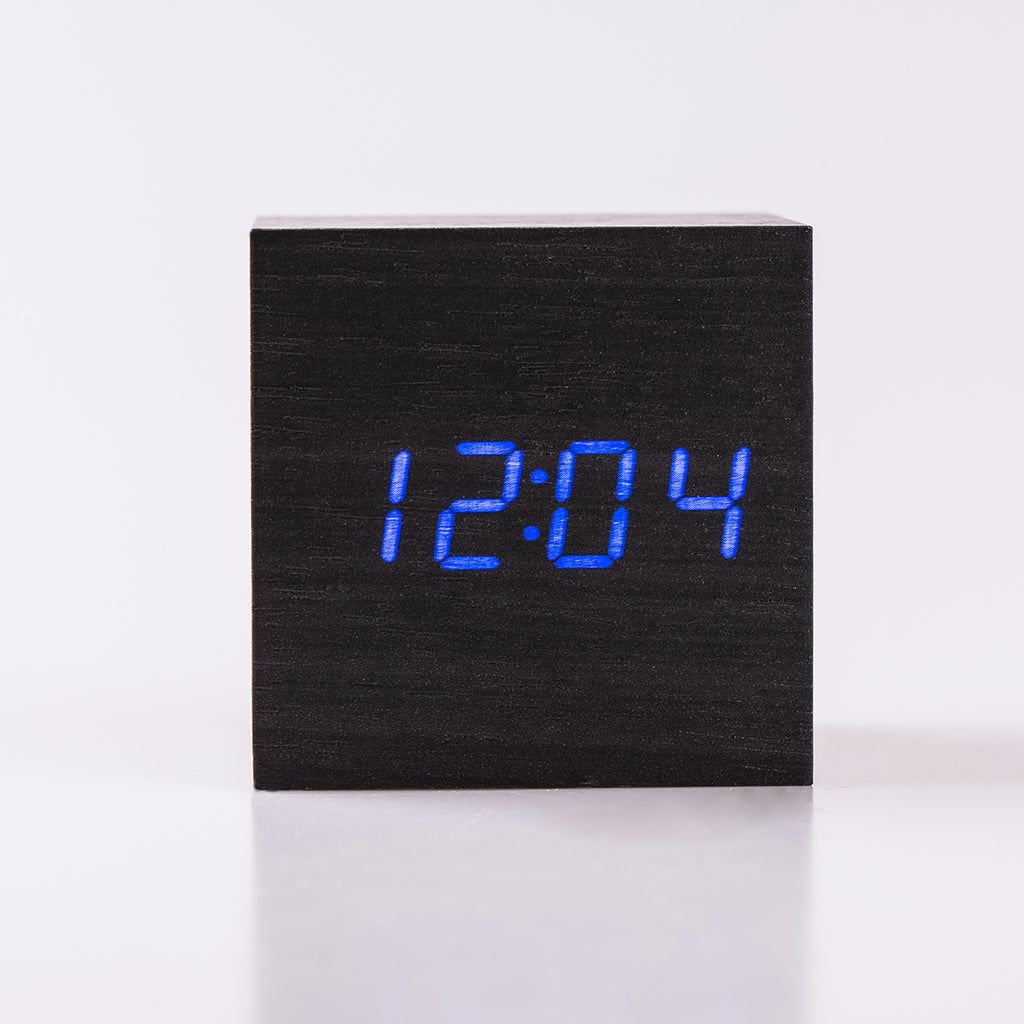Buy Eco-Friendly Black Wood Alarm Clock with blue LED display in cube design. Stylish bedside clock for modern bedrooms, battery or USB powered.