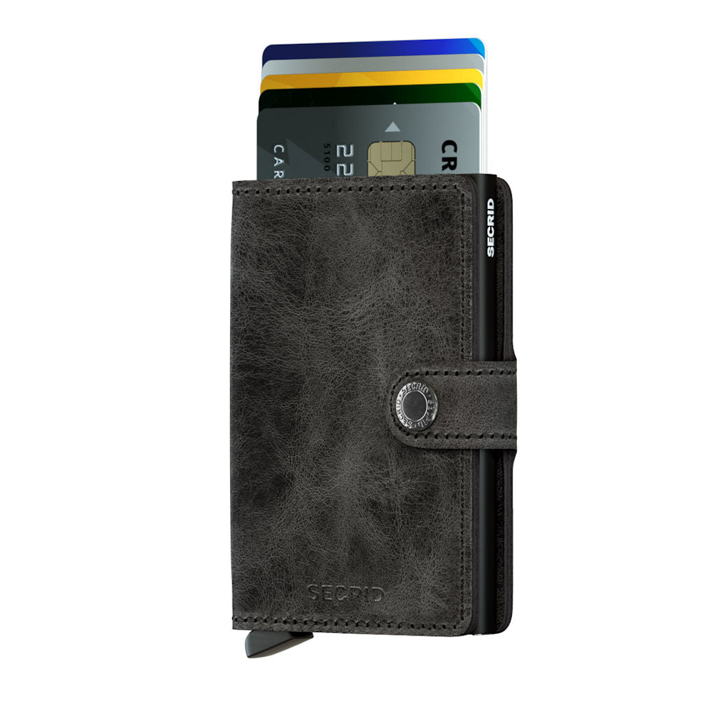 Buy Vintage Black Secrid Miniwallet with RFID protection. Slim leather wallet securely holds cards with easy-access pop-up mechanism.