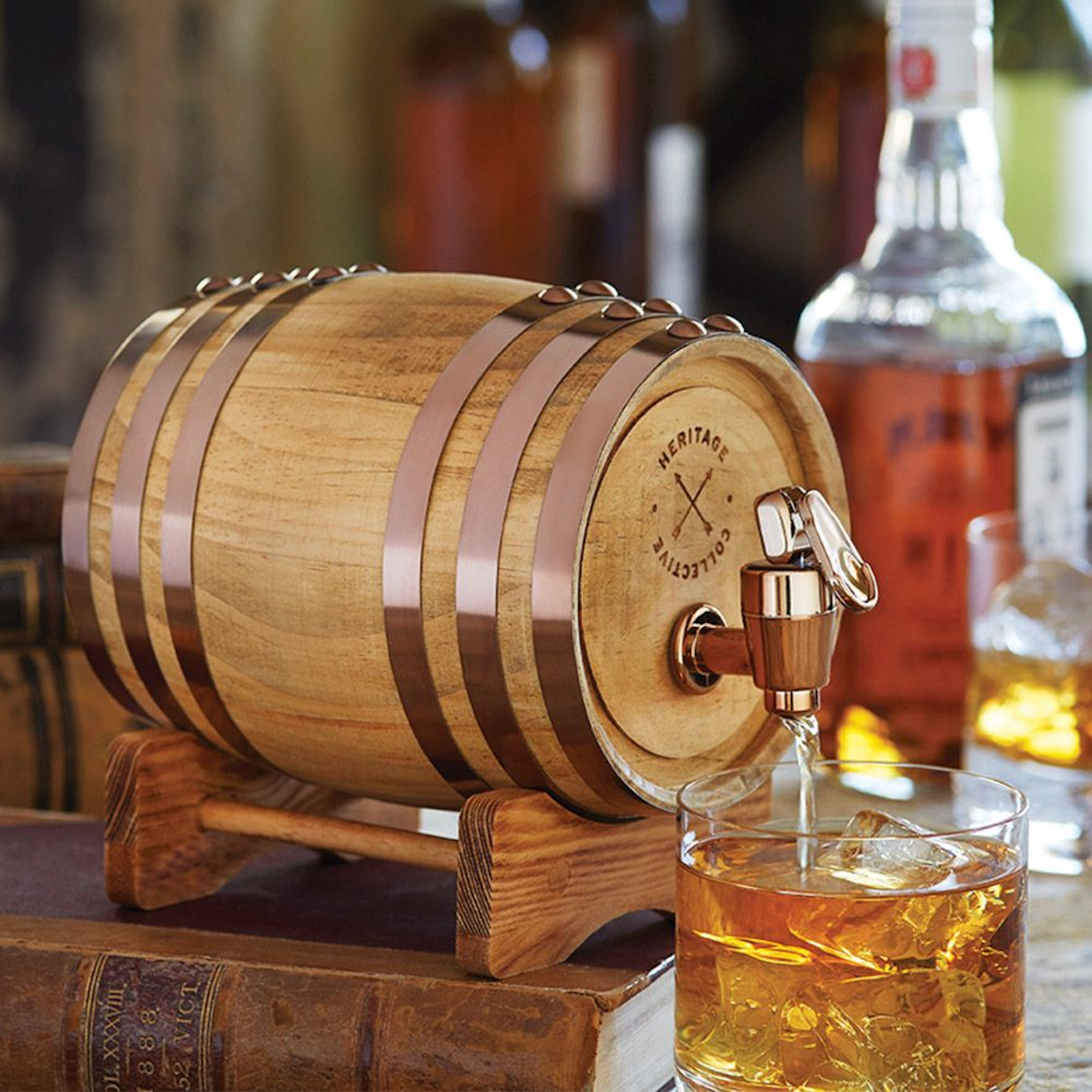 Whiskey Barrel wood drink dispenser with spout pouring whiskey into glass, ideal for home bar and party use. Gift for men.